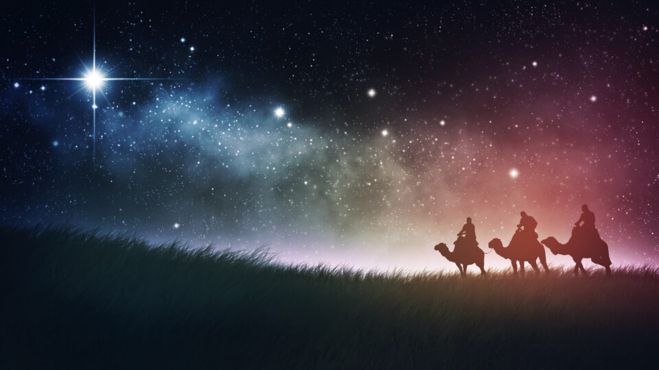 Three wise men follow star with space background.